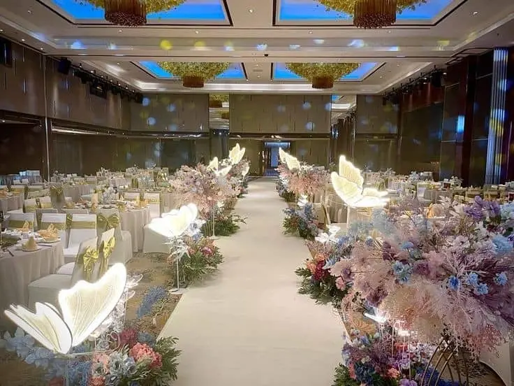 Wedding aisle dressed with soft florals and ambient lighting